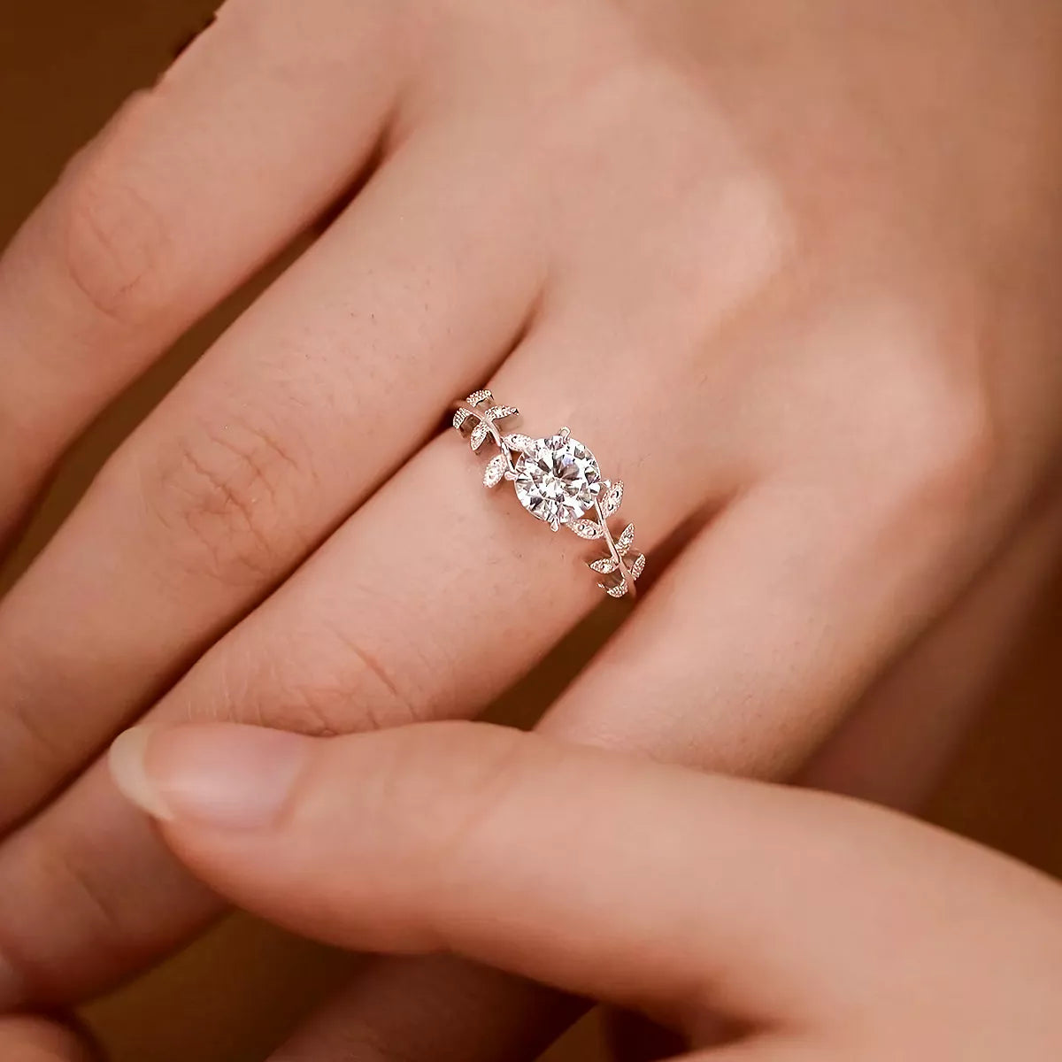Blooming Rose Sterling Silver Ring with zircon centerpiece and delicate leaf accents on finger