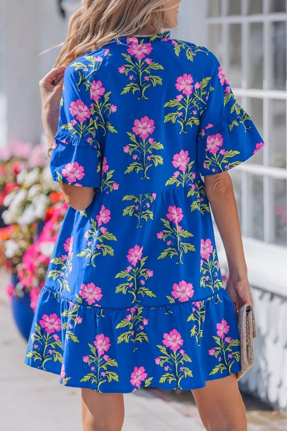 Floral tiered dress with flutter sleeves and tie neckline