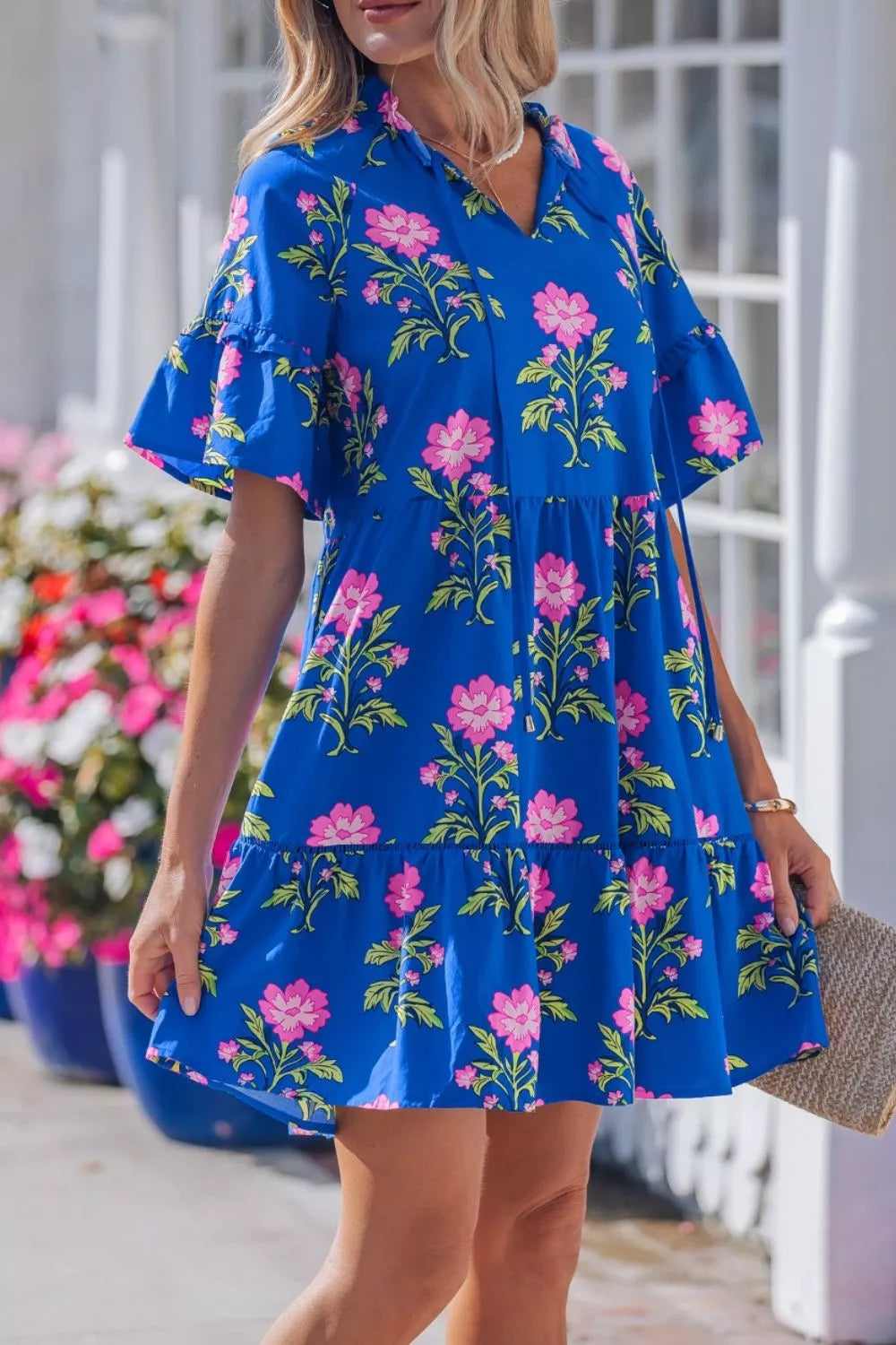 Floral tiered dress with flutter sleeves and tie neckline