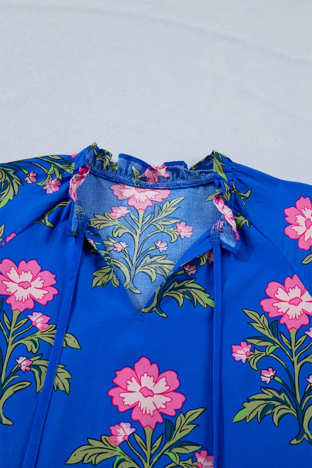 Floral tiered dress with flutter sleeves and tie neckline