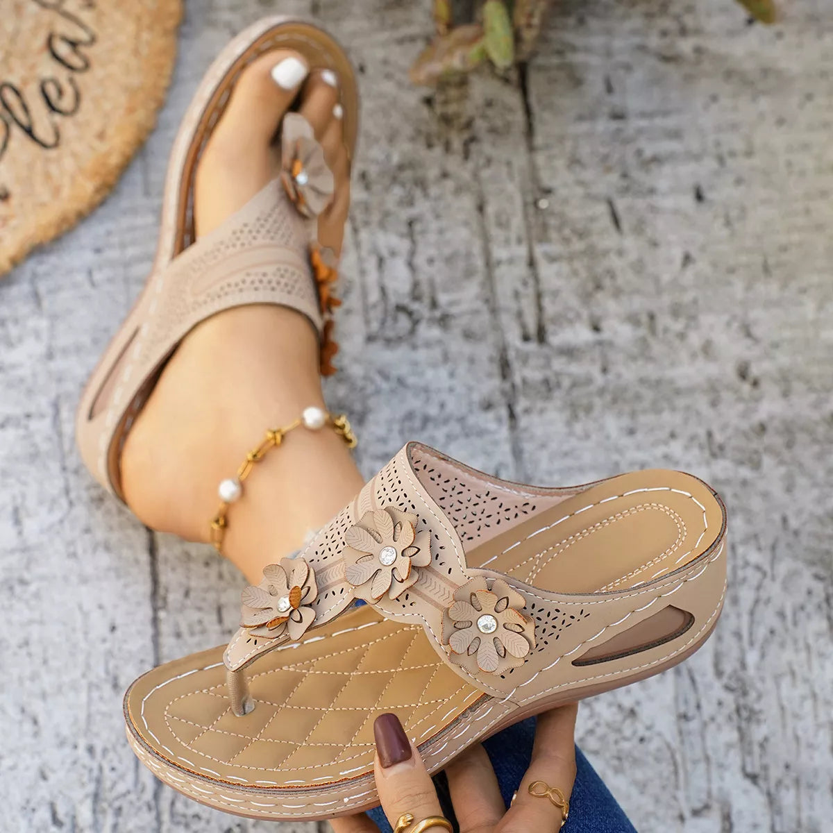 Low heel slip-on thong sandals with floral appliqué details, cutout accents, PU leather material, and rubber sole shown in multiple colors.