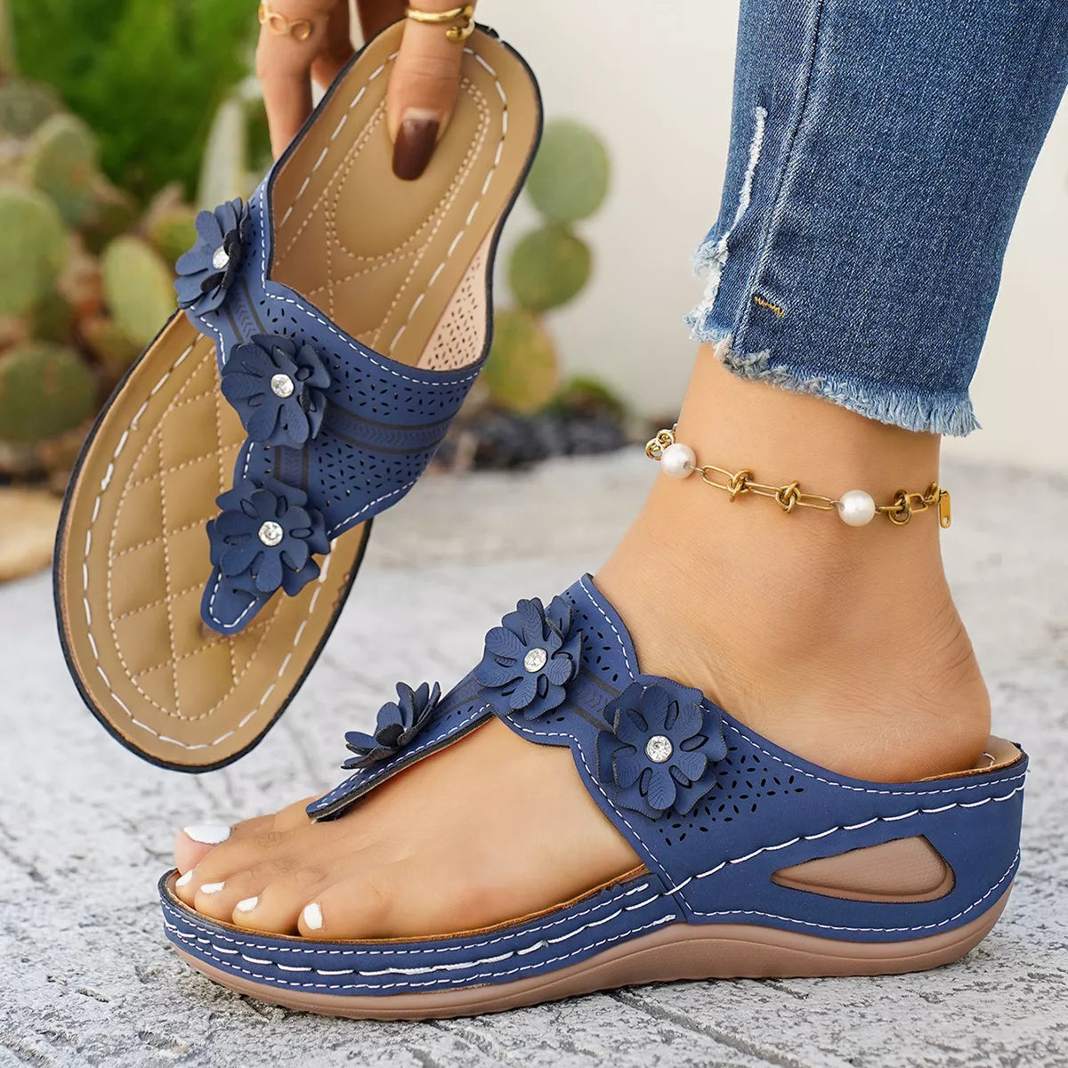 Low heel slip-on thong sandals with floral appliqué details, cutout accents, PU leather material, and rubber sole shown in multiple colors.