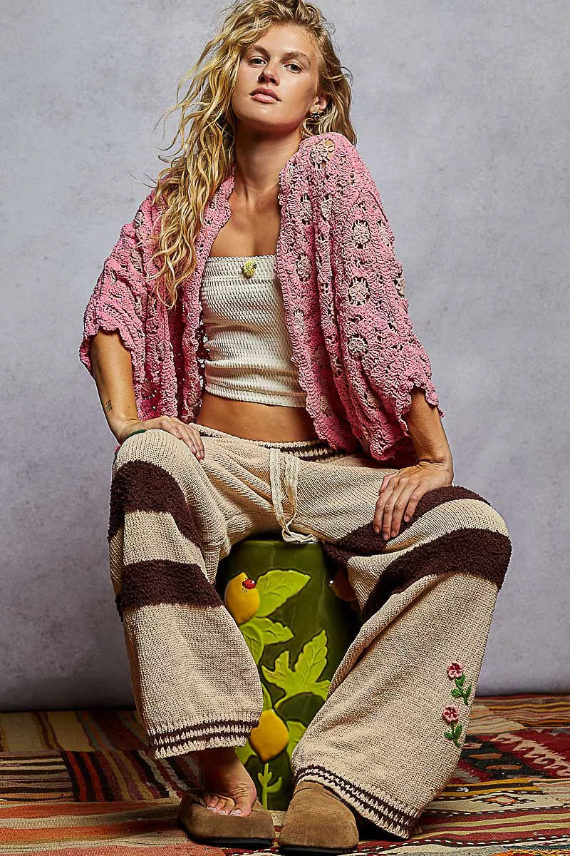 Pink crochet chenille cardigan with floral pattern and relaxed batwing fit.