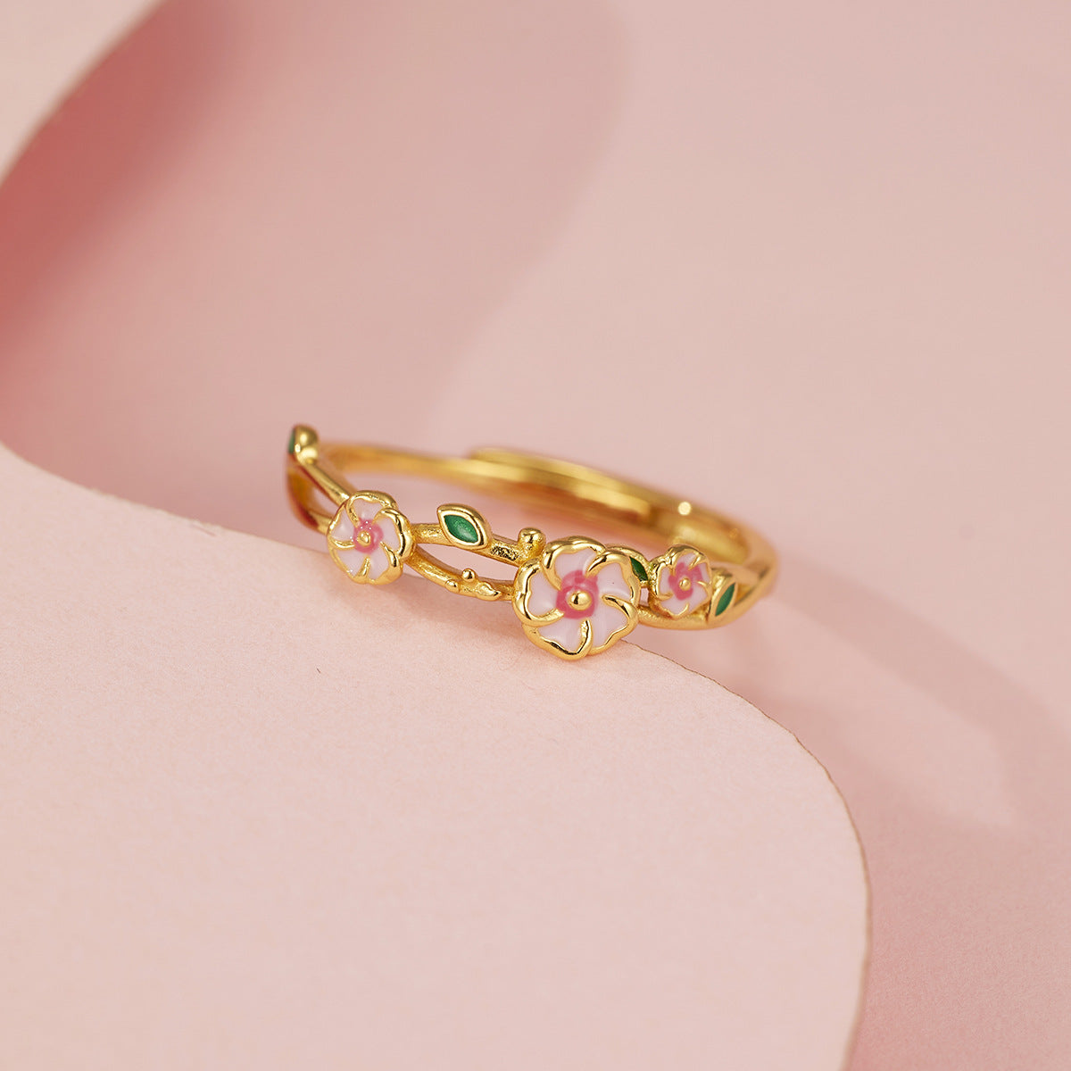 18K gold plated and sterling silver floral ring with pink enamel blossoms and green leaf details