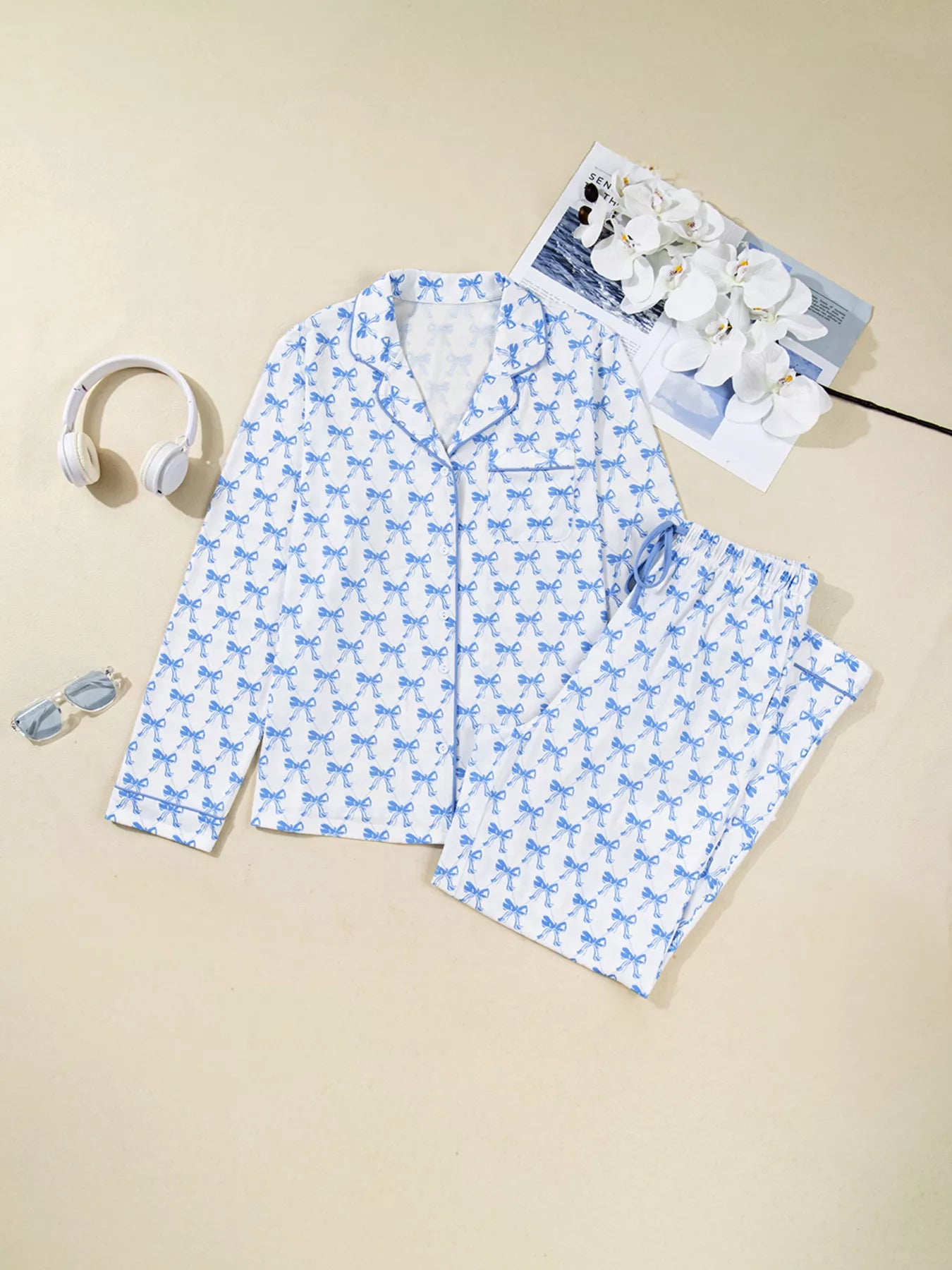 Women’s two-piece pajama set with blue bow print, button-down top, and drawstring pants, cozy and stylish sleepwear.