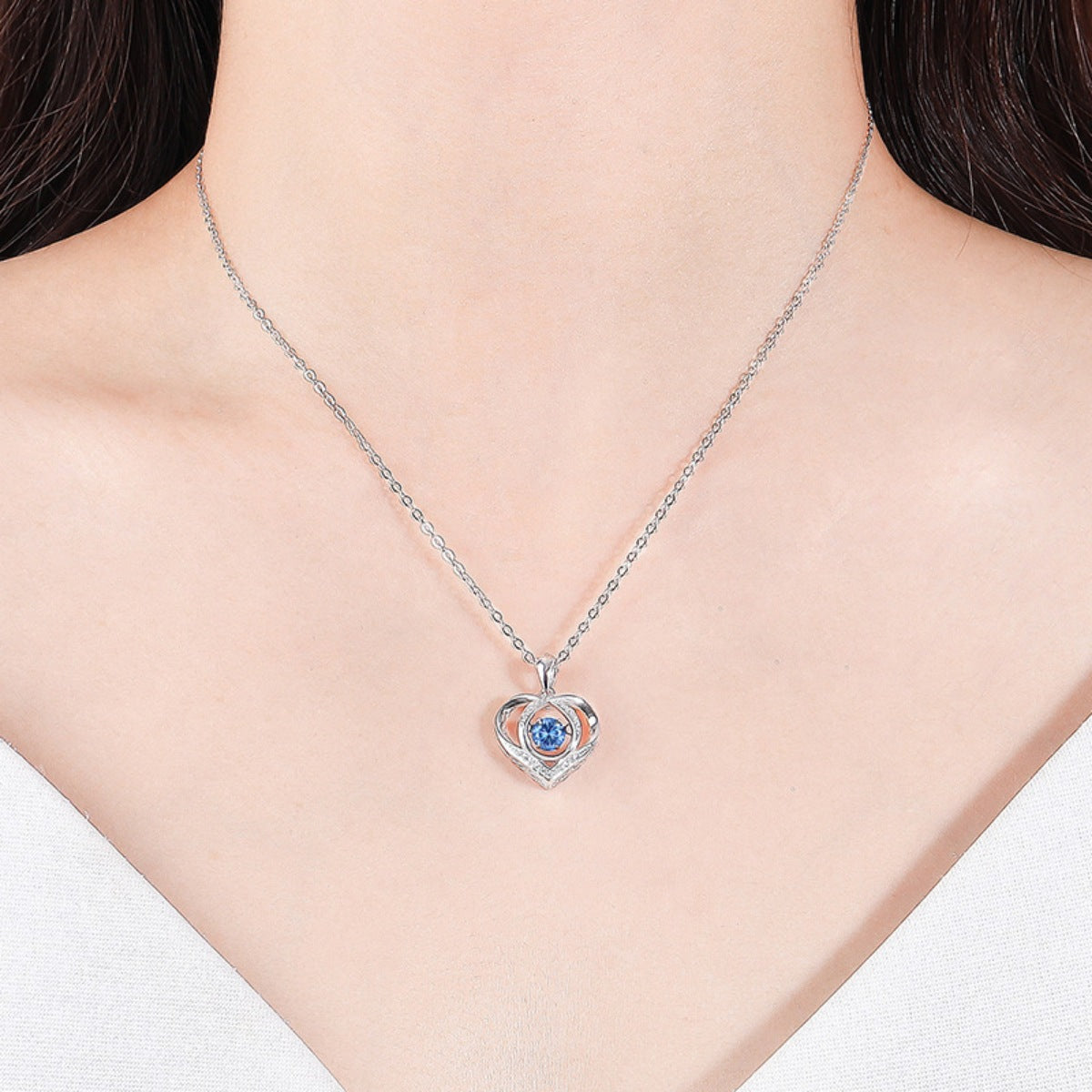 Sterling silver heart pendant necklace with blue gemstone center