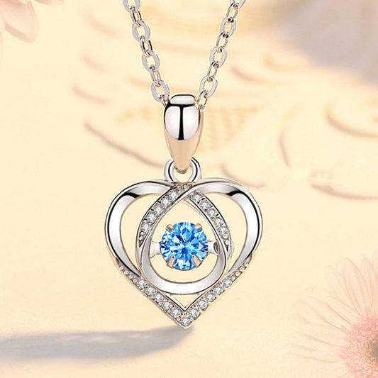 Sterling silver heart pendant necklace with blue gemstone center