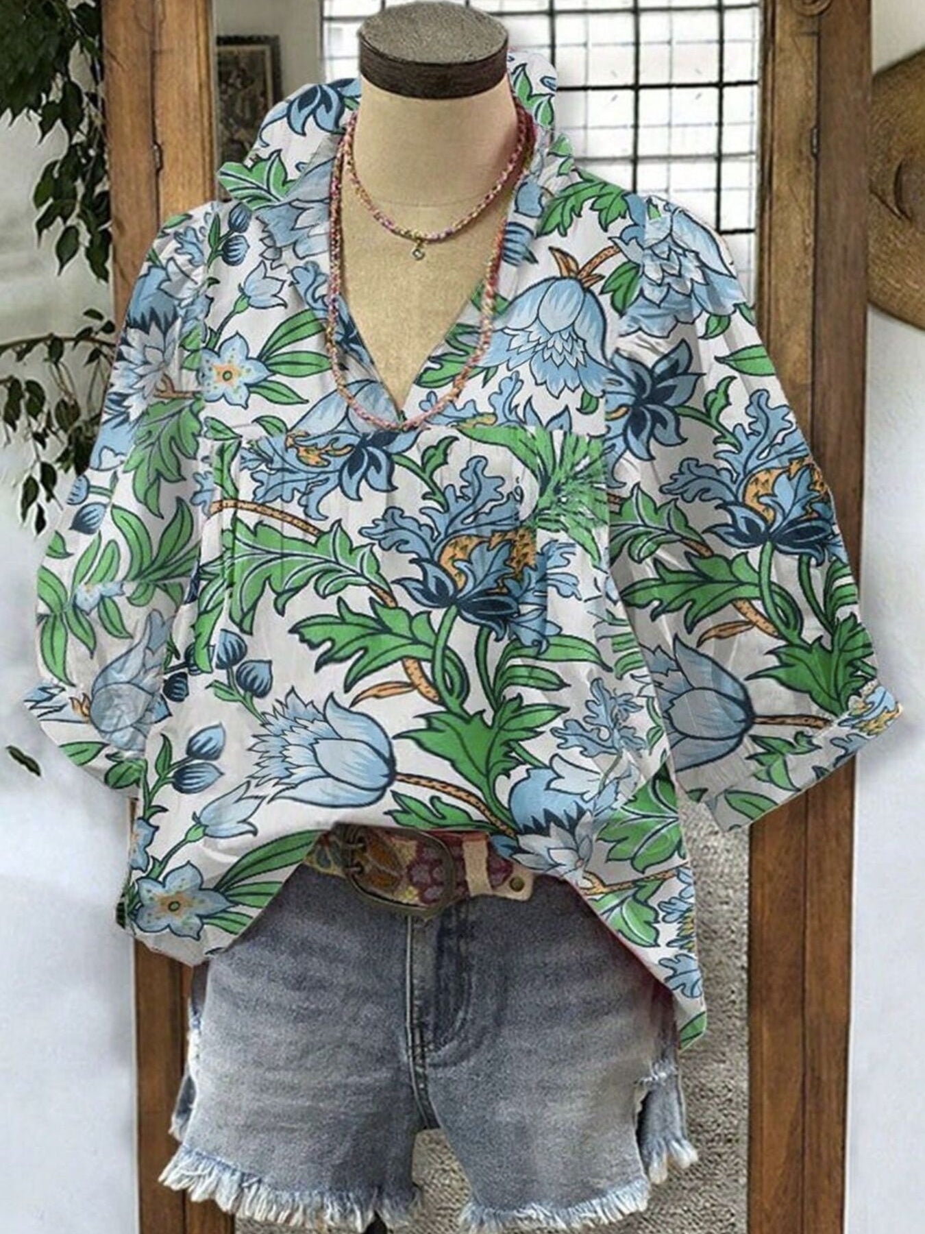 White blouse with blue green floral botanical print and gathered neckline