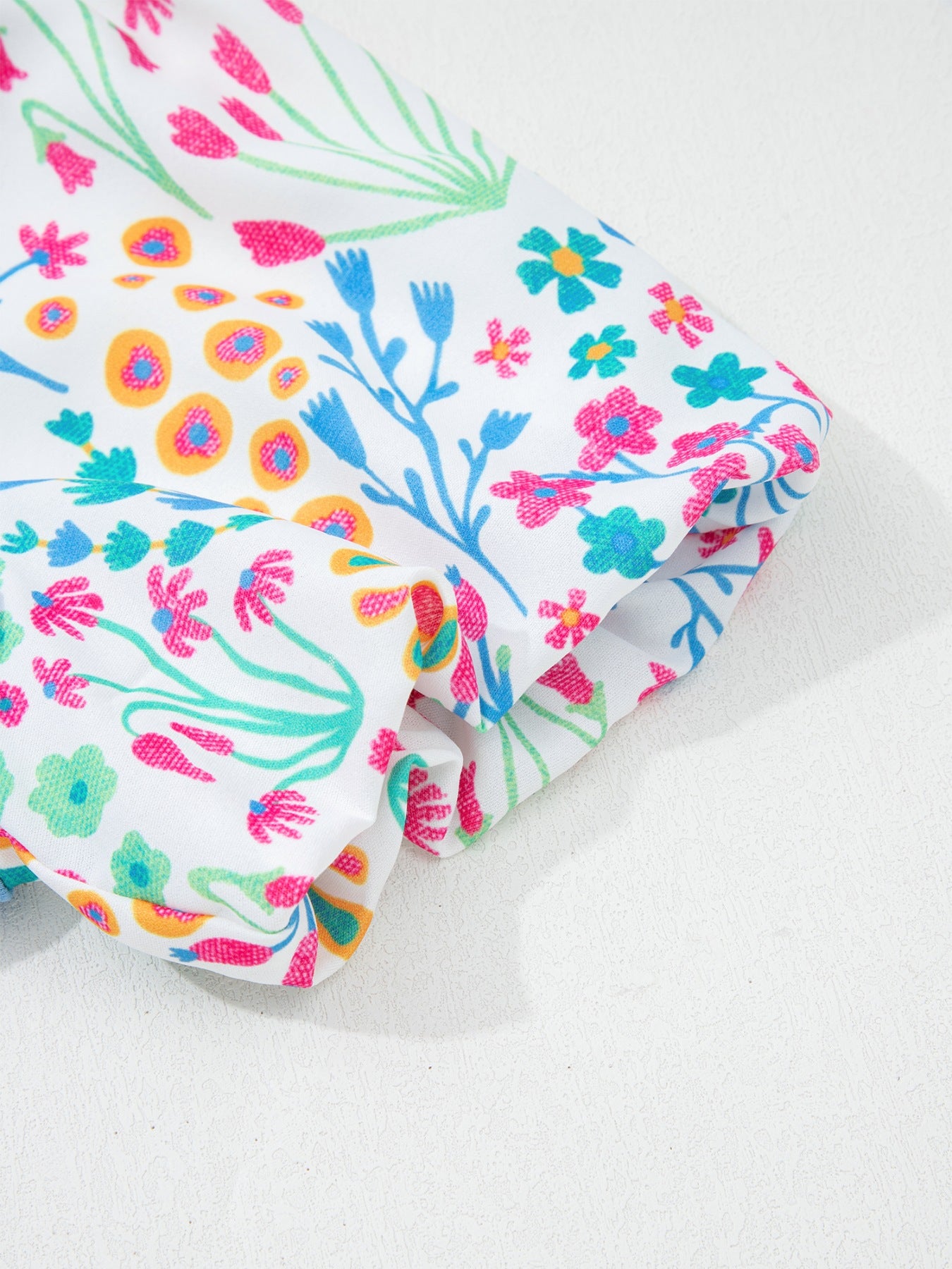 Blue textured top with colorful floral puff sleeves