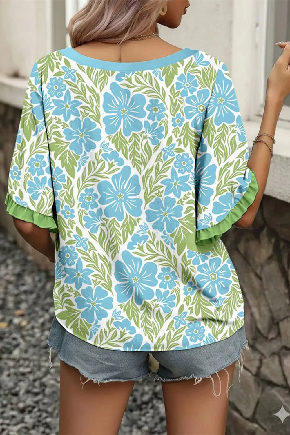 blue floral boho blouse with green ruffle trim and flutter sleeves