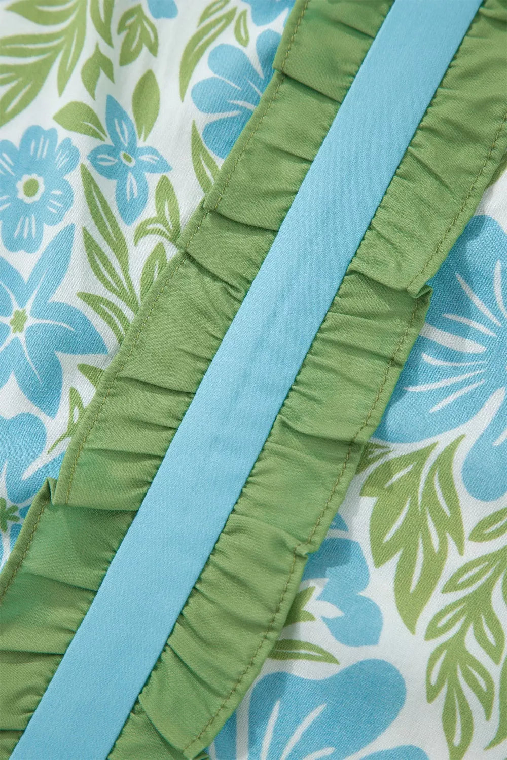 blue floral boho blouse with green ruffle trim and flutter sleeves