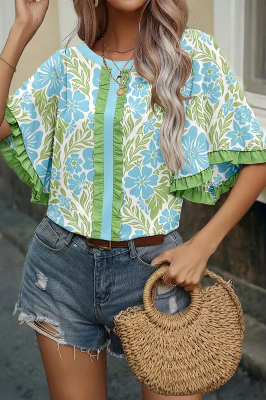 blue floral boho blouse with green ruffle trim and flutter sleeves