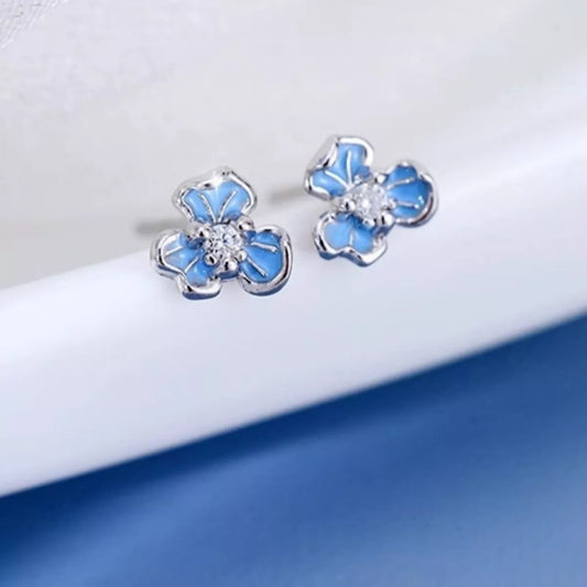 Sterling silver floral stud earrings with blue enamel petals