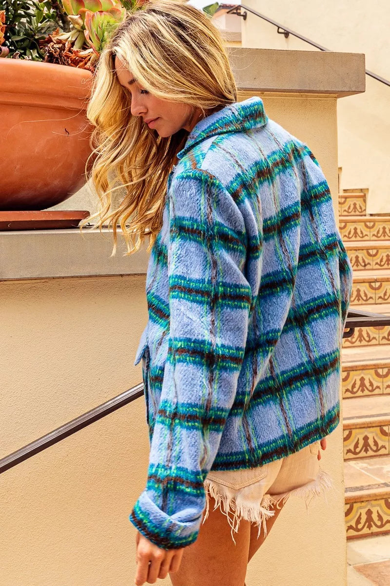 Blue plaid button-front jacket with flap pockets, structured collar, soft brushed texture, and relaxed cropped fit.