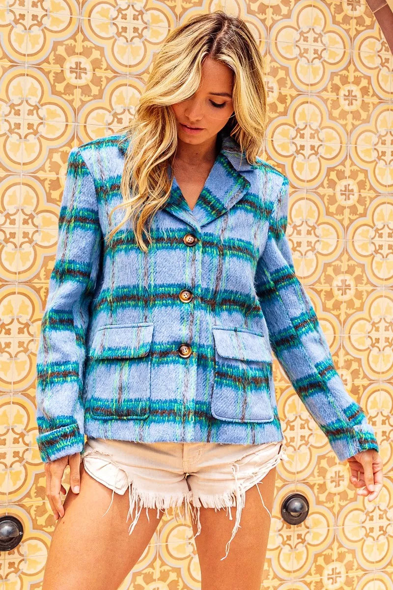 Blue plaid button-front jacket with flap pockets, structured collar, soft brushed texture, and relaxed cropped fit.
