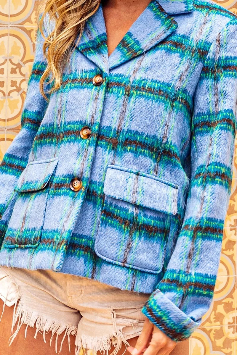 Blue plaid button-front jacket with flap pockets, structured collar, soft brushed texture, and relaxed cropped fit.