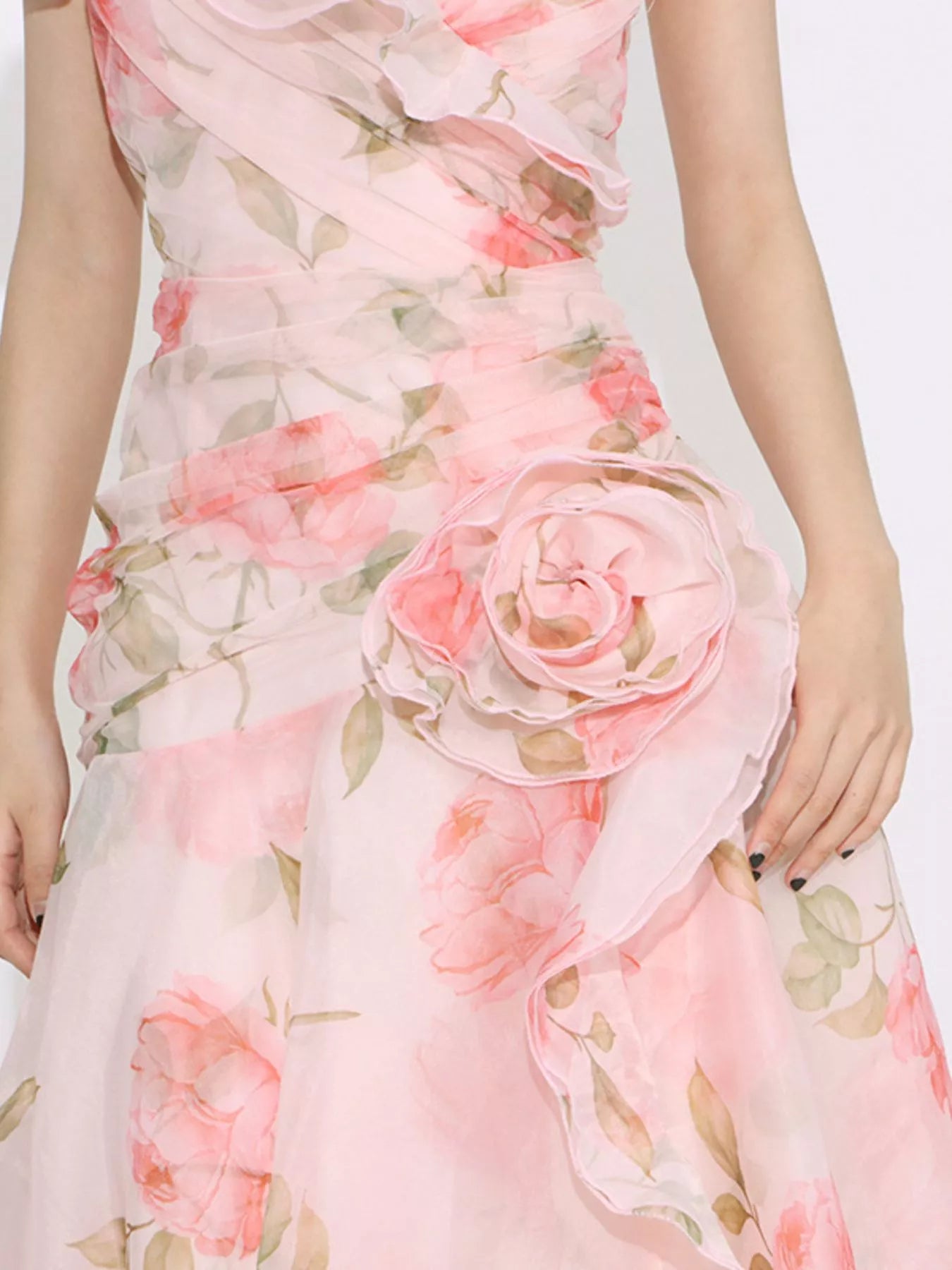Pink floral tiered gown with ruffled details, puff sleeves, and rose appliqué accents.