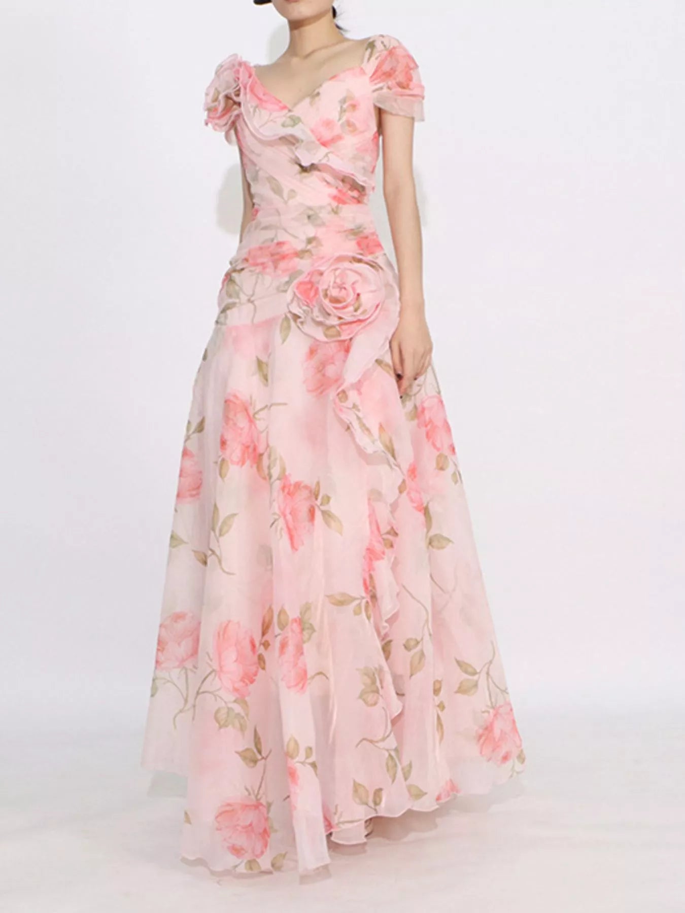 Pink floral tiered gown with ruffled details, puff sleeves, and rose appliqué accents.
