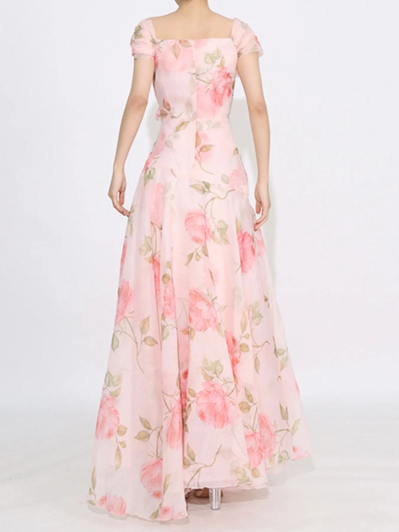 Pink floral tiered gown with ruffled details, puff sleeves, and rose appliqué accents.