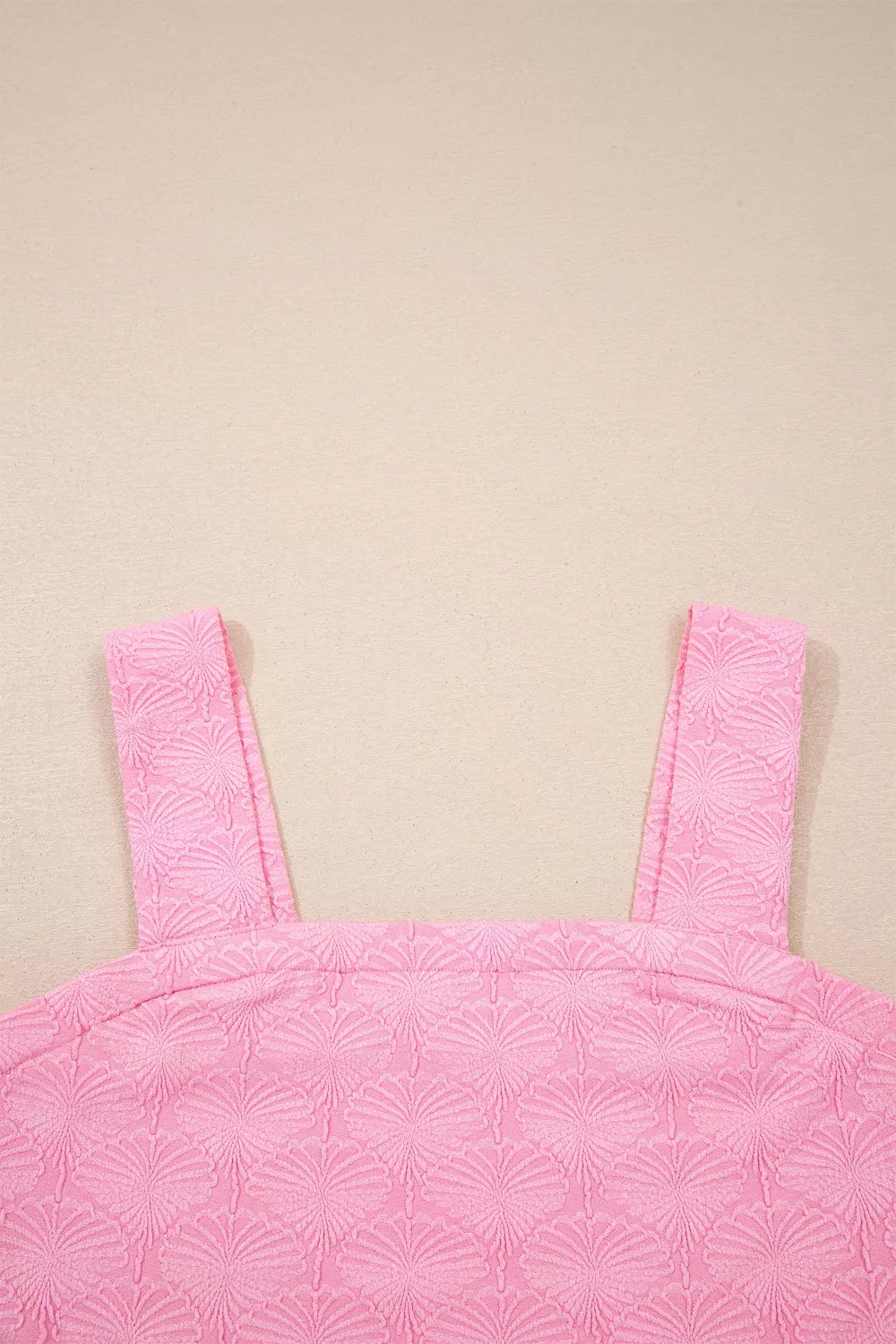 Pink square neck tank top with floral textured fabric, wide straps, and a slightly stretchy fit styled with light denim.