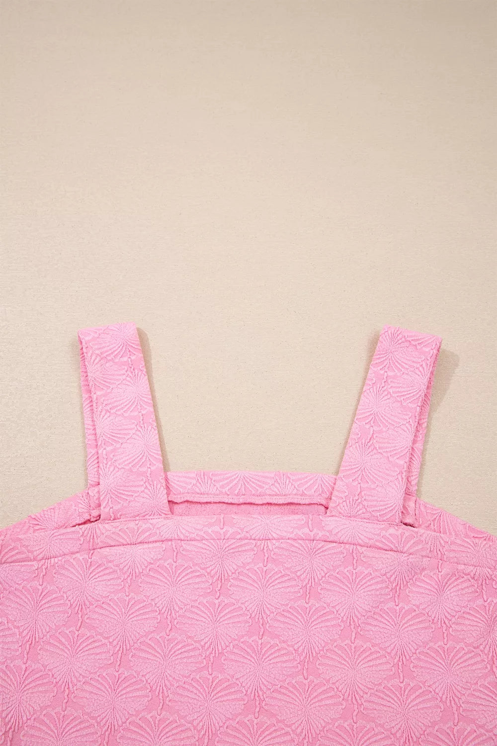Pink square neck tank top with floral textured fabric, wide straps, and a slightly stretchy fit styled with light denim.