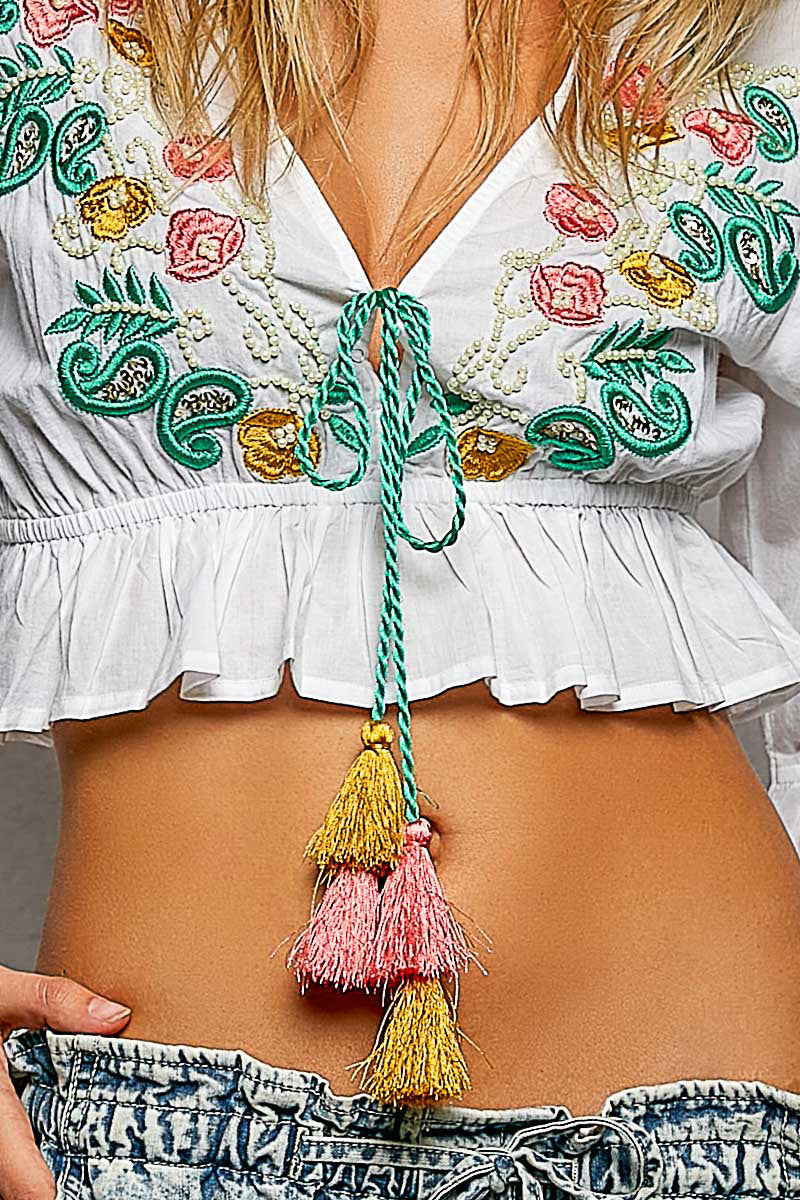 Embroidered cotton crop top with tassel tie neckline and ruffle sleeves