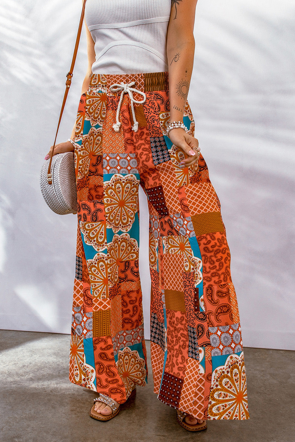 Bohemian patchwork drawstring wide leg pants in orange – casual chic boho trousers with multicolored design.