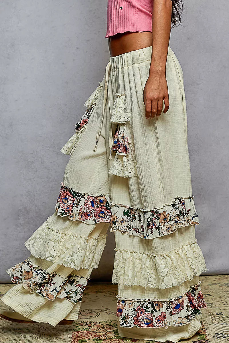Wide-leg cotton pants with lace and floral tiered ruffles, drawstring waistband, and bohemian style