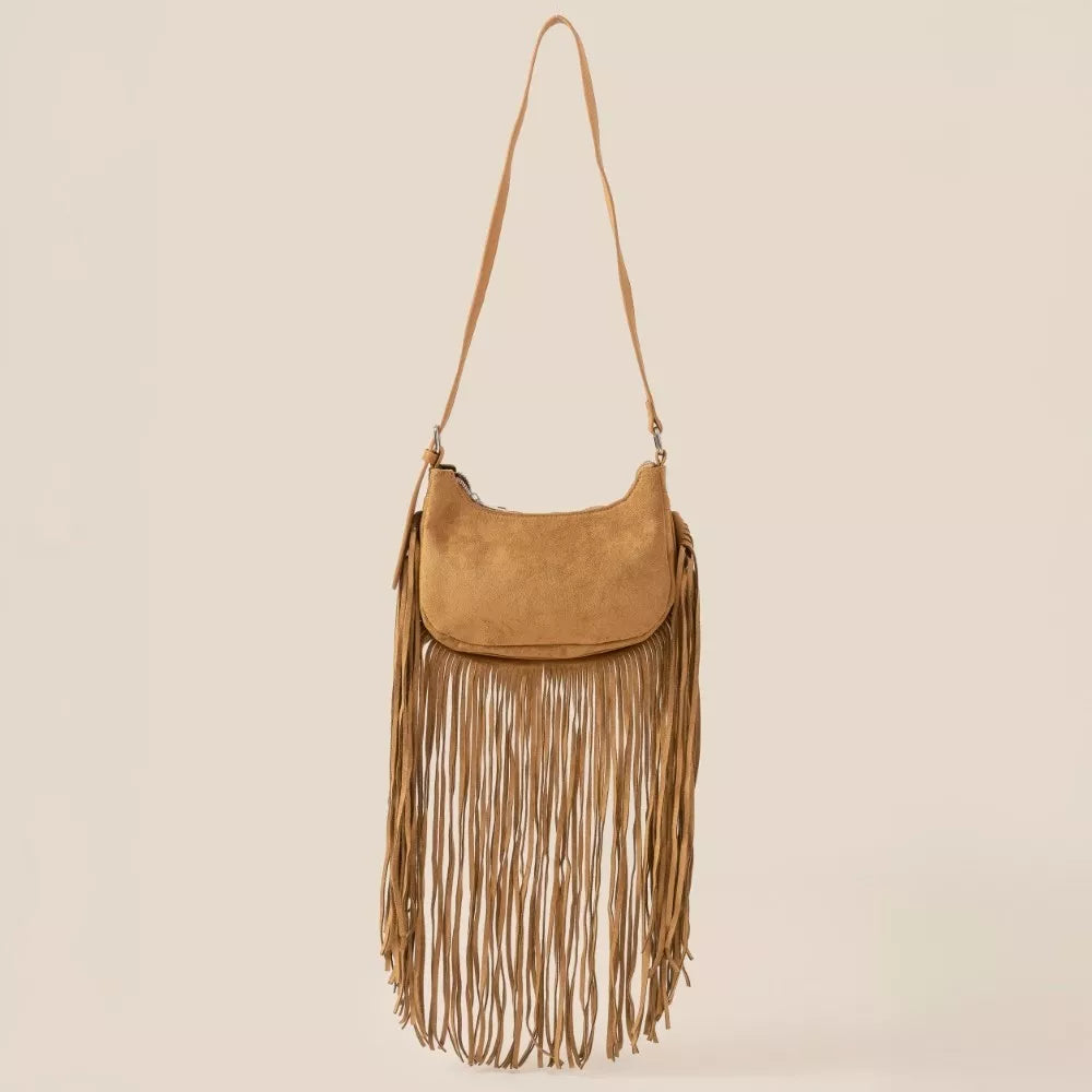 Tan suede crossbody bag with long fringe detailing and boho-inspired design.