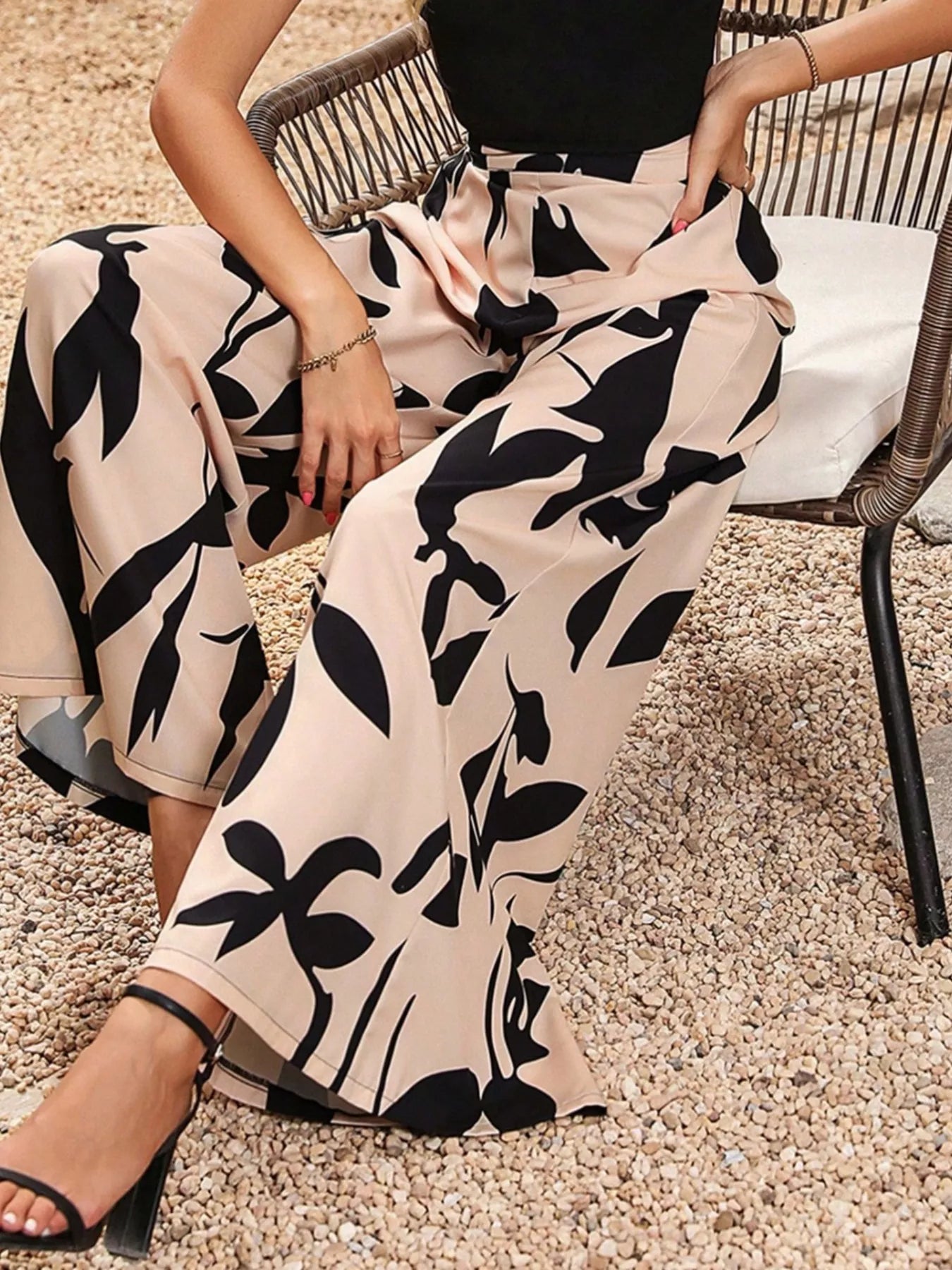 Beige wide leg pants with bold black botanical print