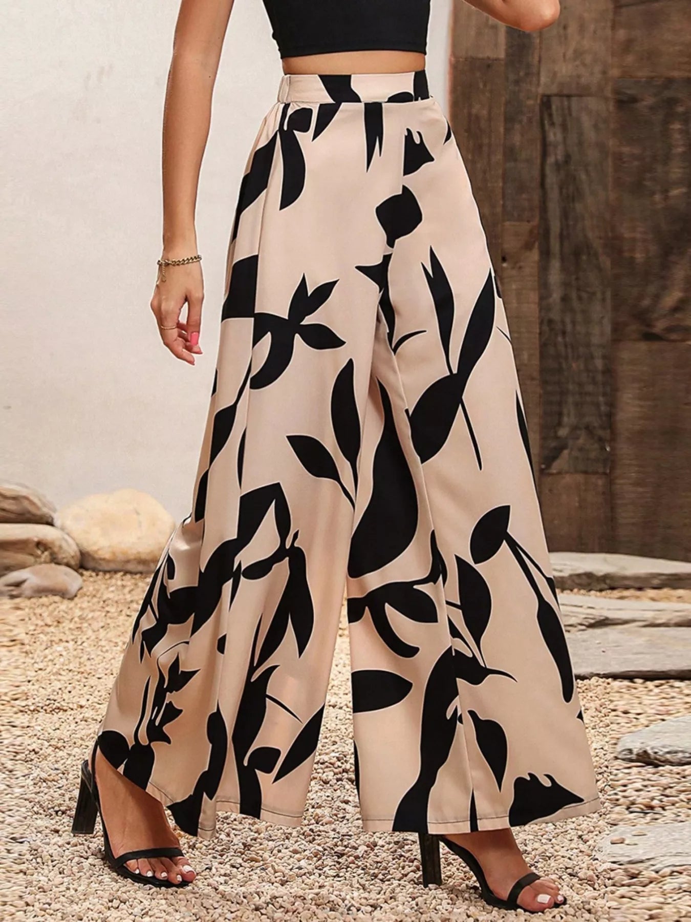 Beige wide leg pants with bold black botanical print