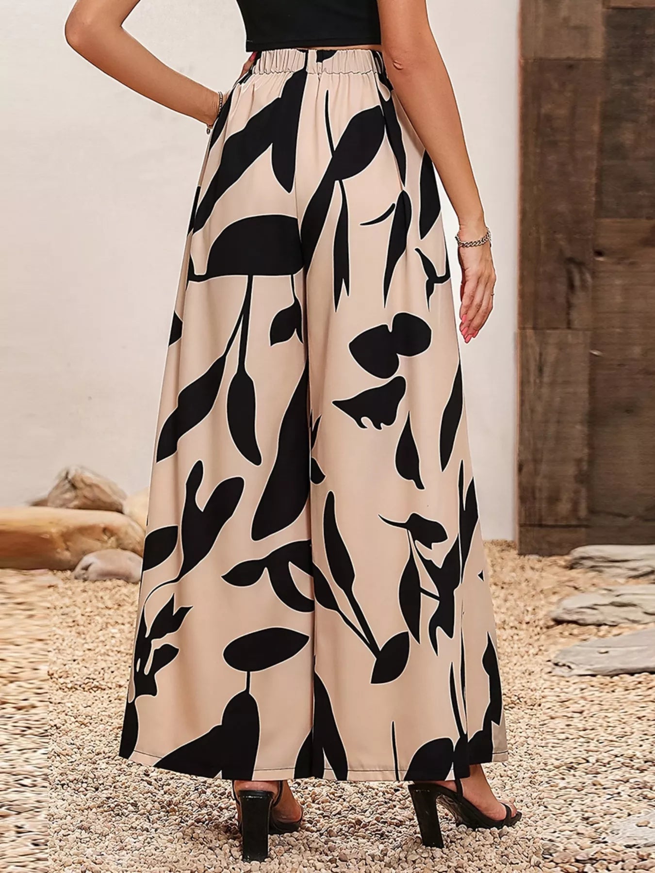 Beige wide leg pants with bold black botanical print