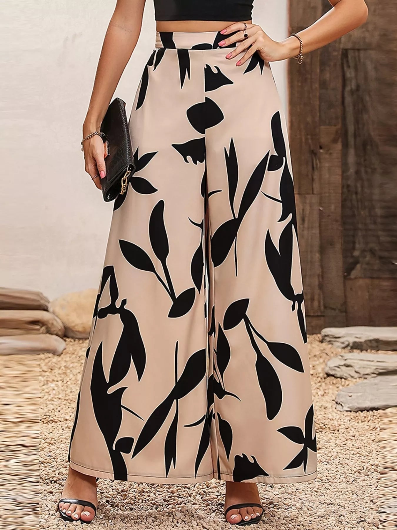 Beige wide leg pants with bold black botanical print