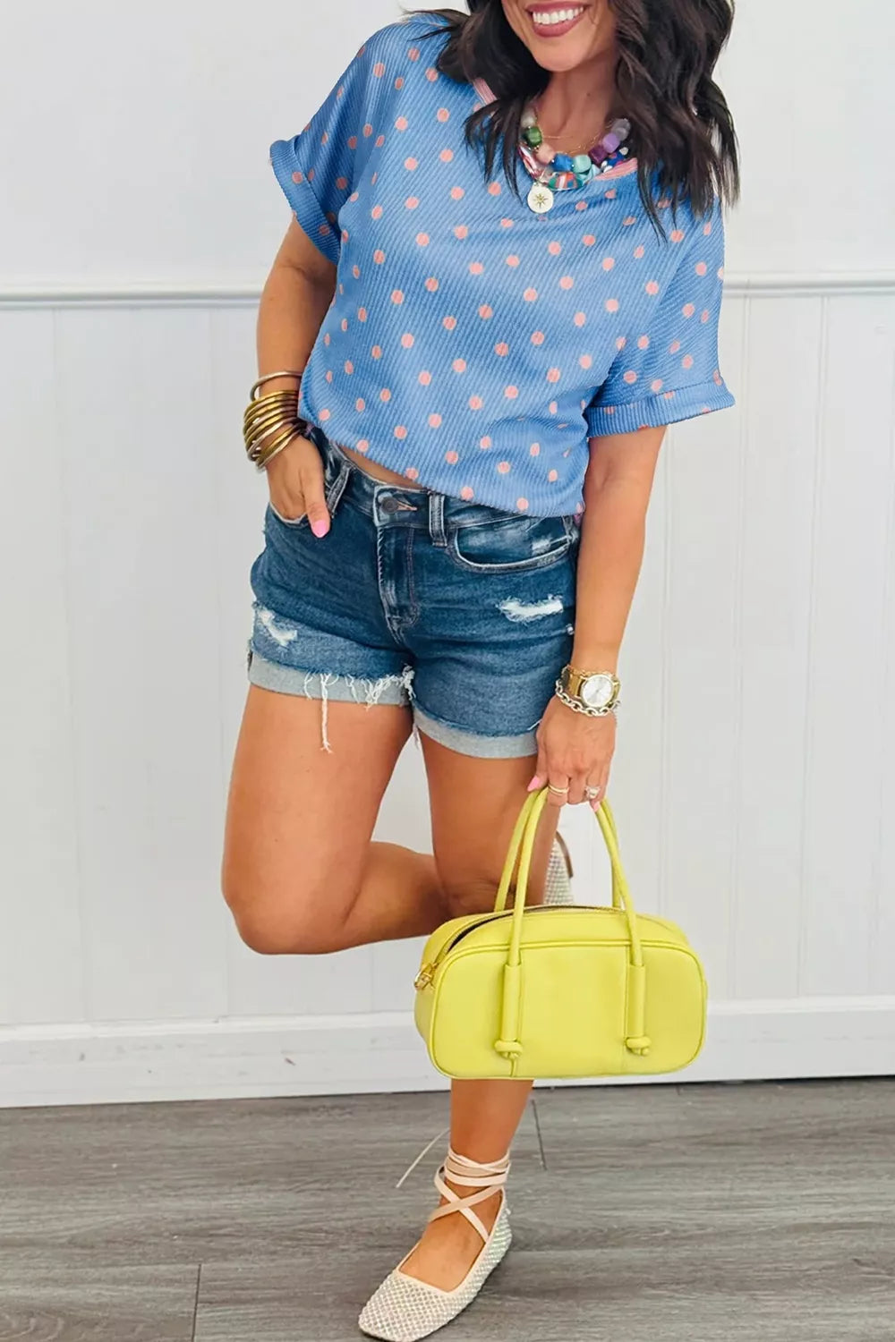 Blue short sleeve top with pink polka dots, textured fabric, and a relaxed slightly stretchy fit.