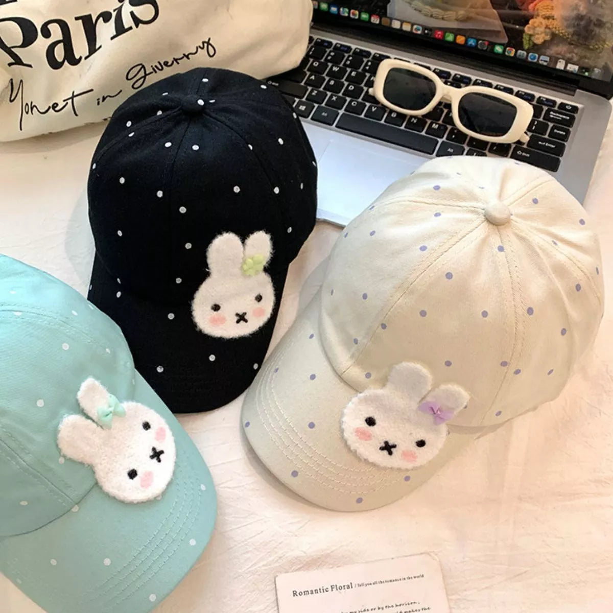 Cotton baseball cap with polka dot print, fuzzy bunny face patch, curved brim, and multiple color options.