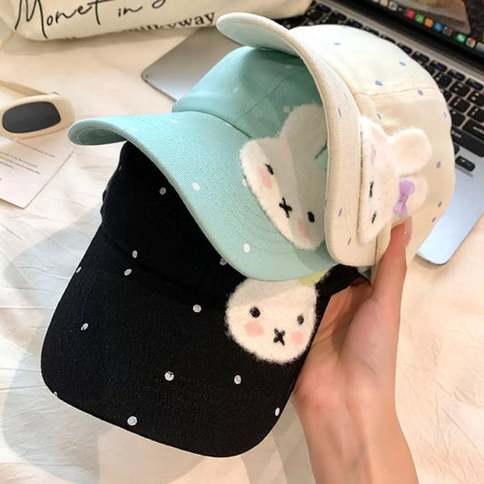 Cotton baseball cap with polka dot print, fuzzy bunny face patch, curved brim, and multiple color options.
