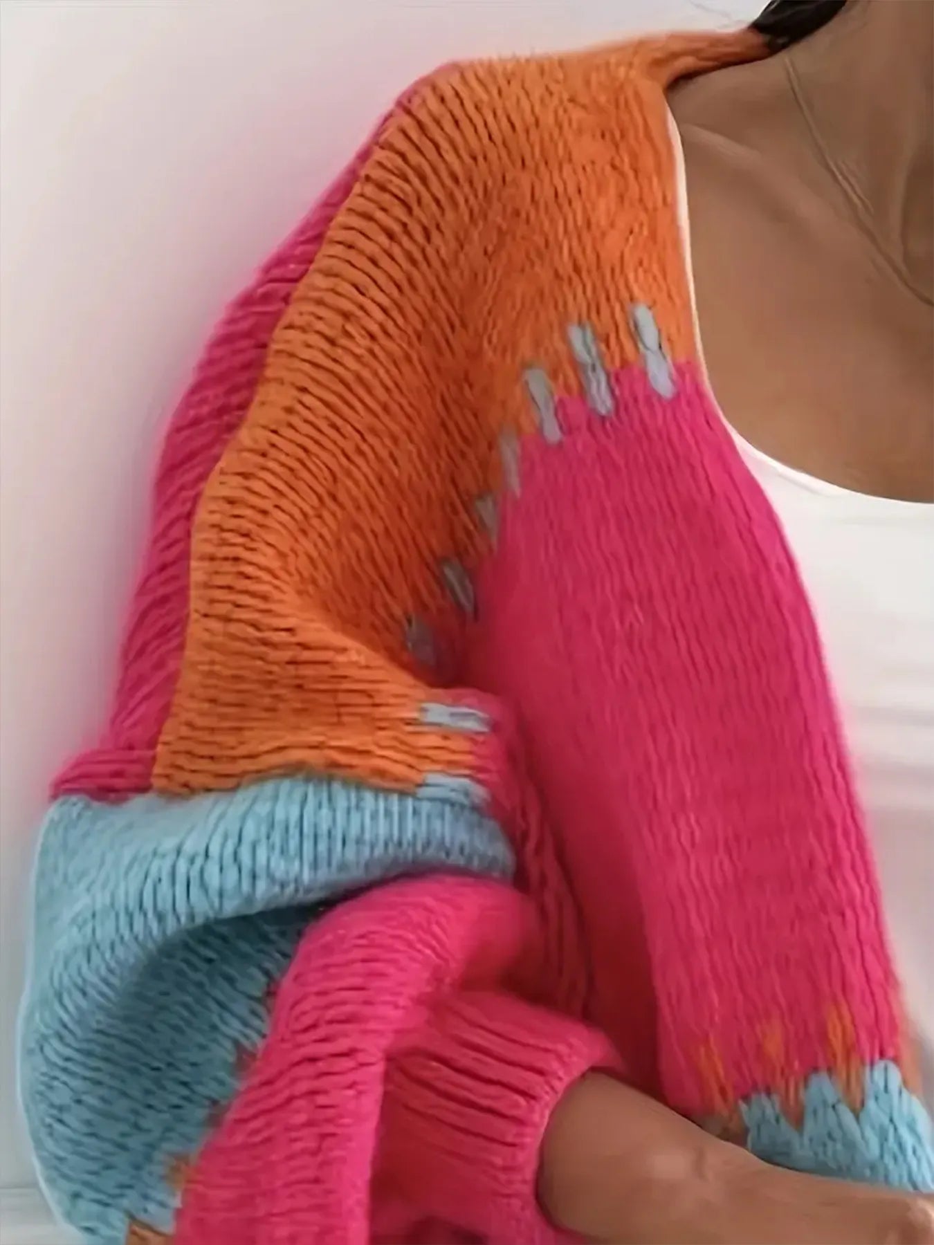 Candy Cloud Cardigan – oversized color block knit in orange, pink, blue, and contrasting tones.
