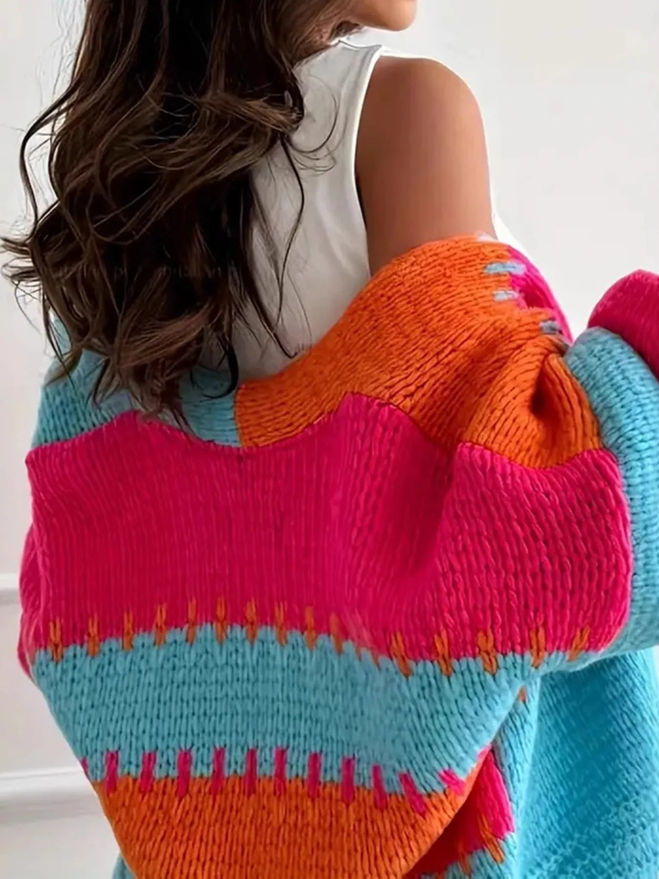 Candy Cloud Cardigan – oversized color block knit in orange, pink, blue, and contrasting tones.