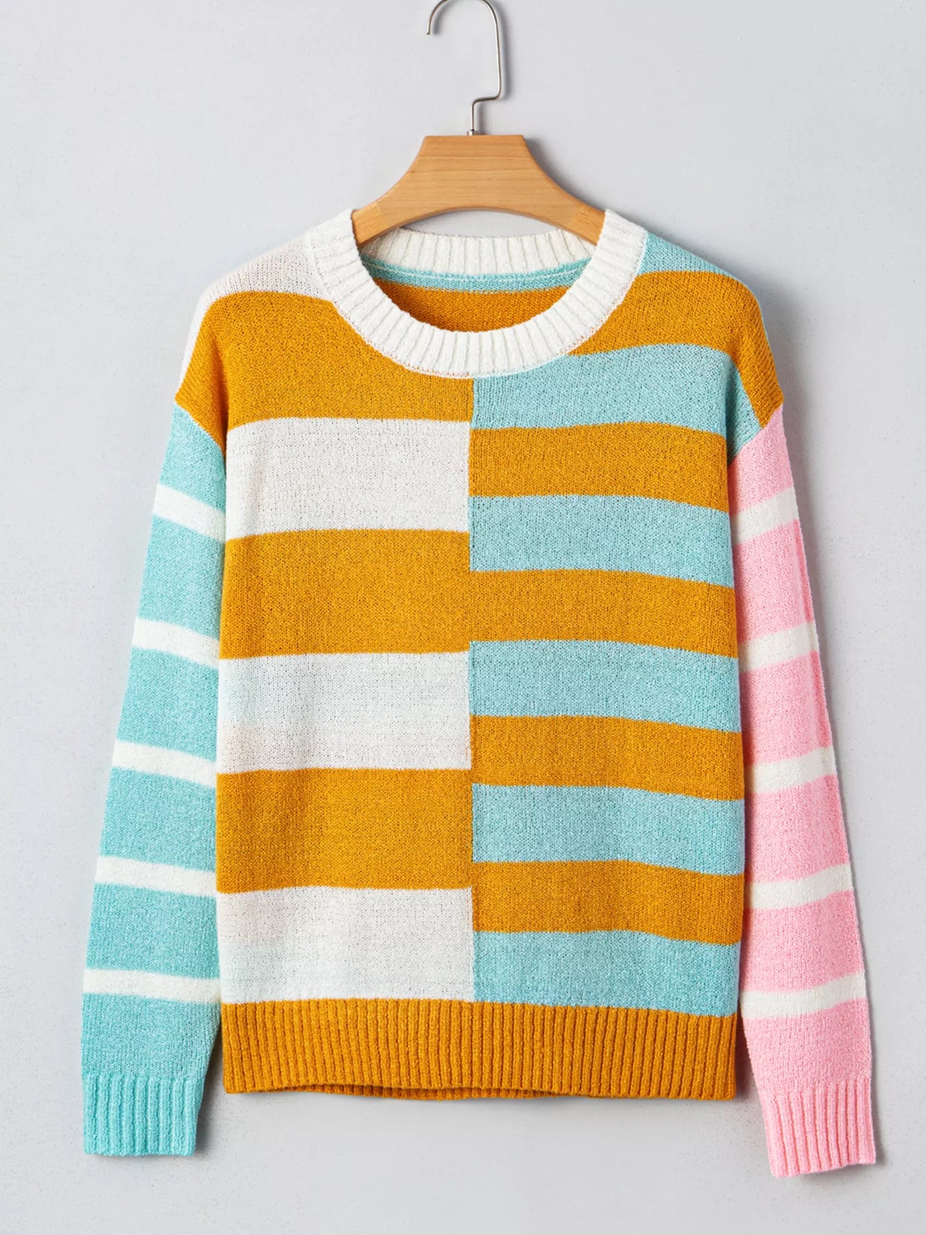 Candy Stripe Sweater – playful color block knit with pink, teal, white, and yellow stripes.