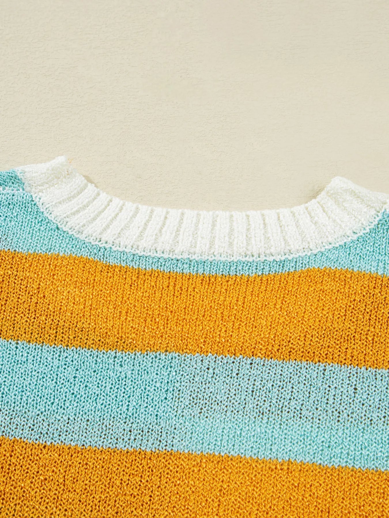 Candy Stripe Sweater – playful color block knit with pink, teal, white, and yellow stripes.