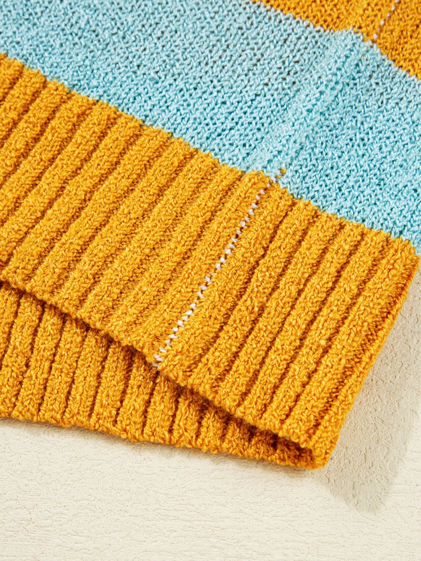 Candy Stripe Sweater – playful color block knit with pink, teal, white, and yellow stripes.