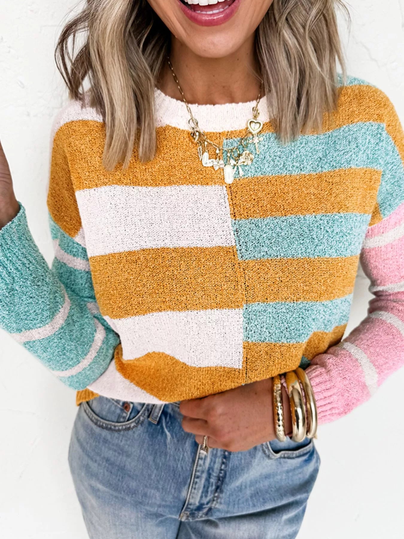 Candy Stripe Sweater – playful color block knit with pink, teal, white, and yellow stripes.