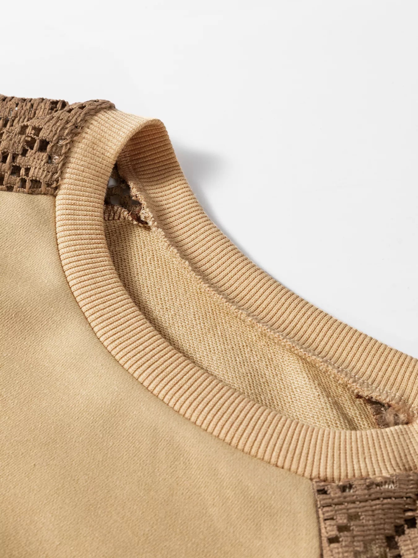 Boho pullover with contrast long sleeves, lace-inspired shoulder panels, ribbed trim, relaxed fit, and slightly stretchy fabric styled with denim.