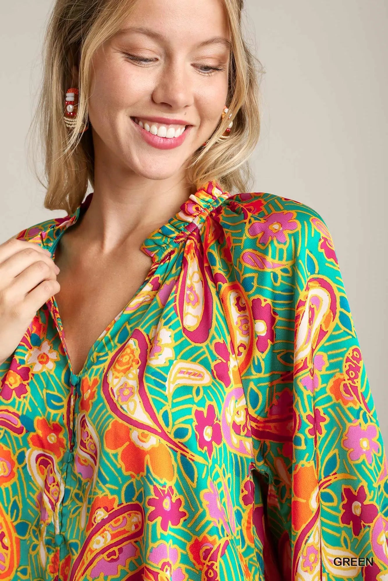 Green satin blouse with multicolor paisley print, ruffle neck, and button-up front – Carnival Paisley Satin Blouse from A Whimsical Affair.