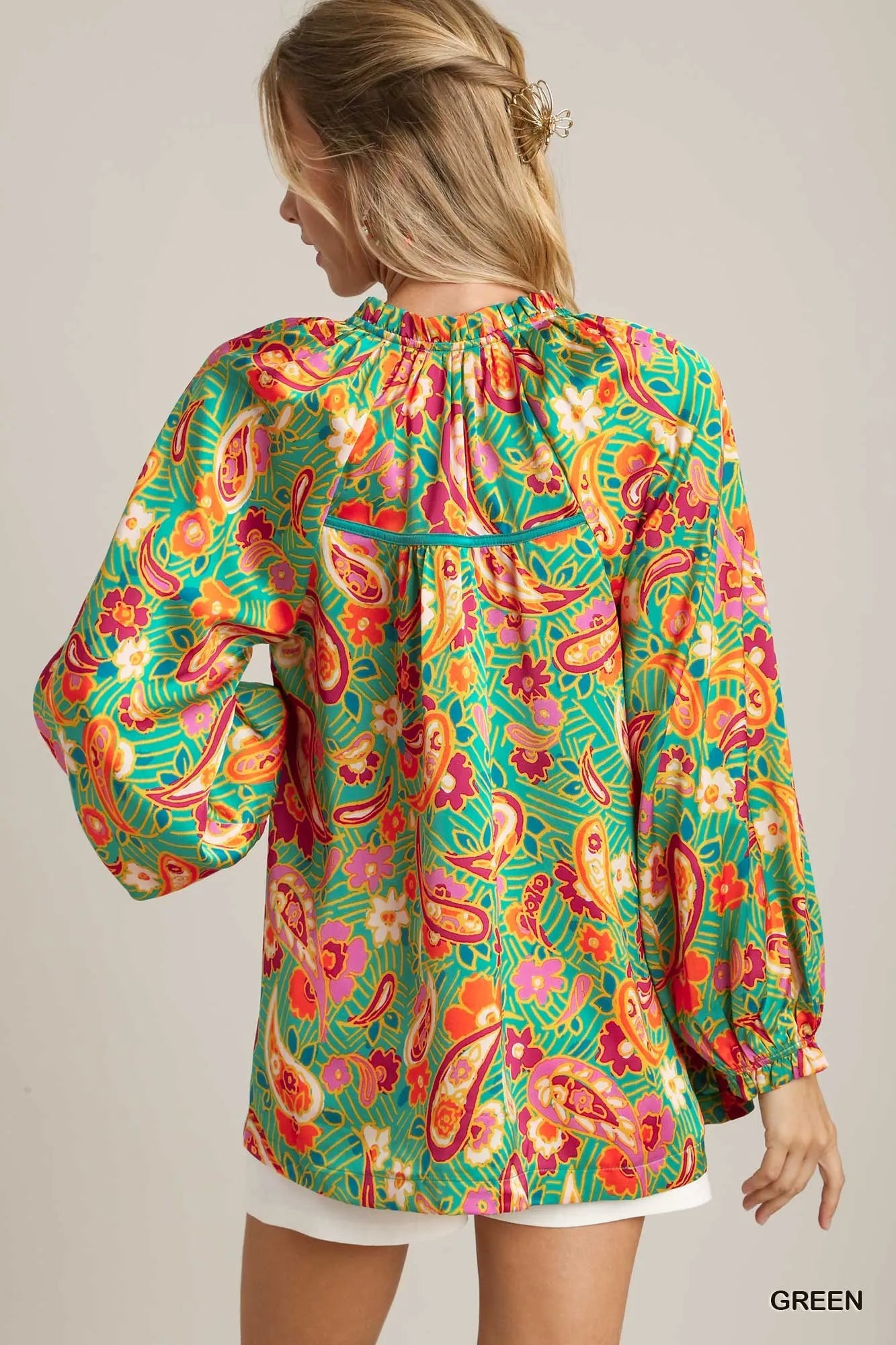 Green satin blouse with multicolor paisley print, ruffle neck, and button-up front – Carnival Paisley Satin Blouse from A Whimsical Affair.