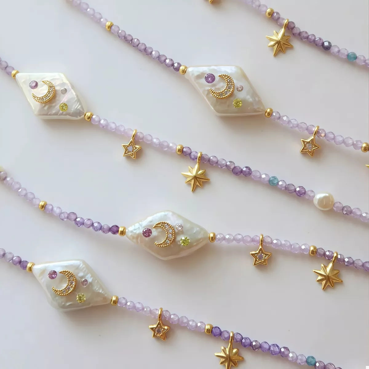 Celestial Colors Pearl Necklace – freshwater pearl and purple beaded necklace with gold-plated star and moon charms.