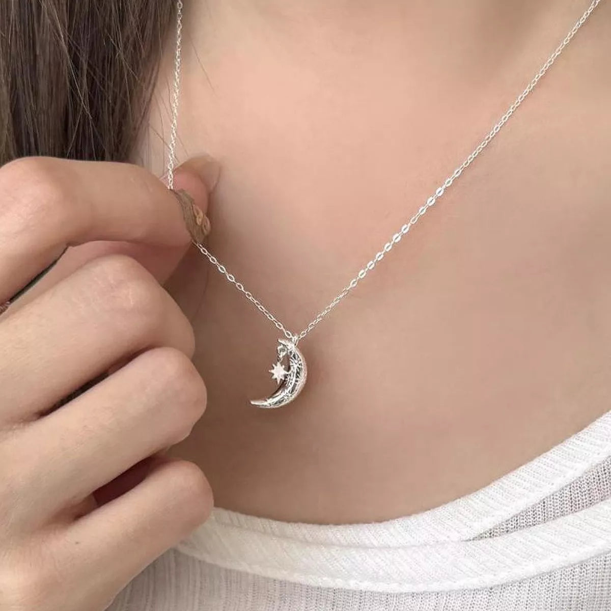 Sterling silver crescent moon pendant necklace with delicate star detail