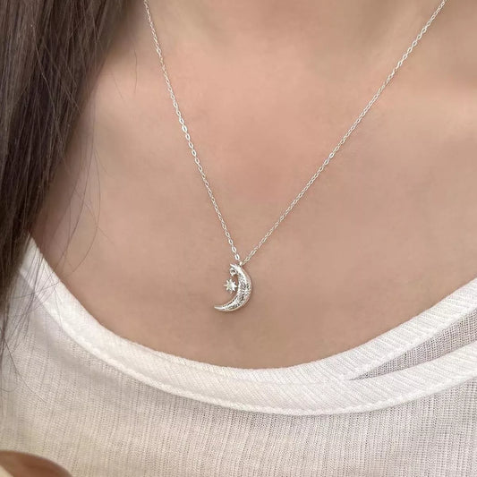Sterling silver crescent moon pendant necklace with delicate star detail
