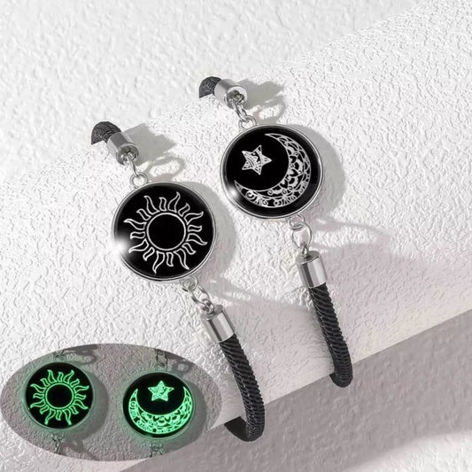 Two-piece glow-in-the-dark bracelet set with sun and moon charms on black braided rope bands