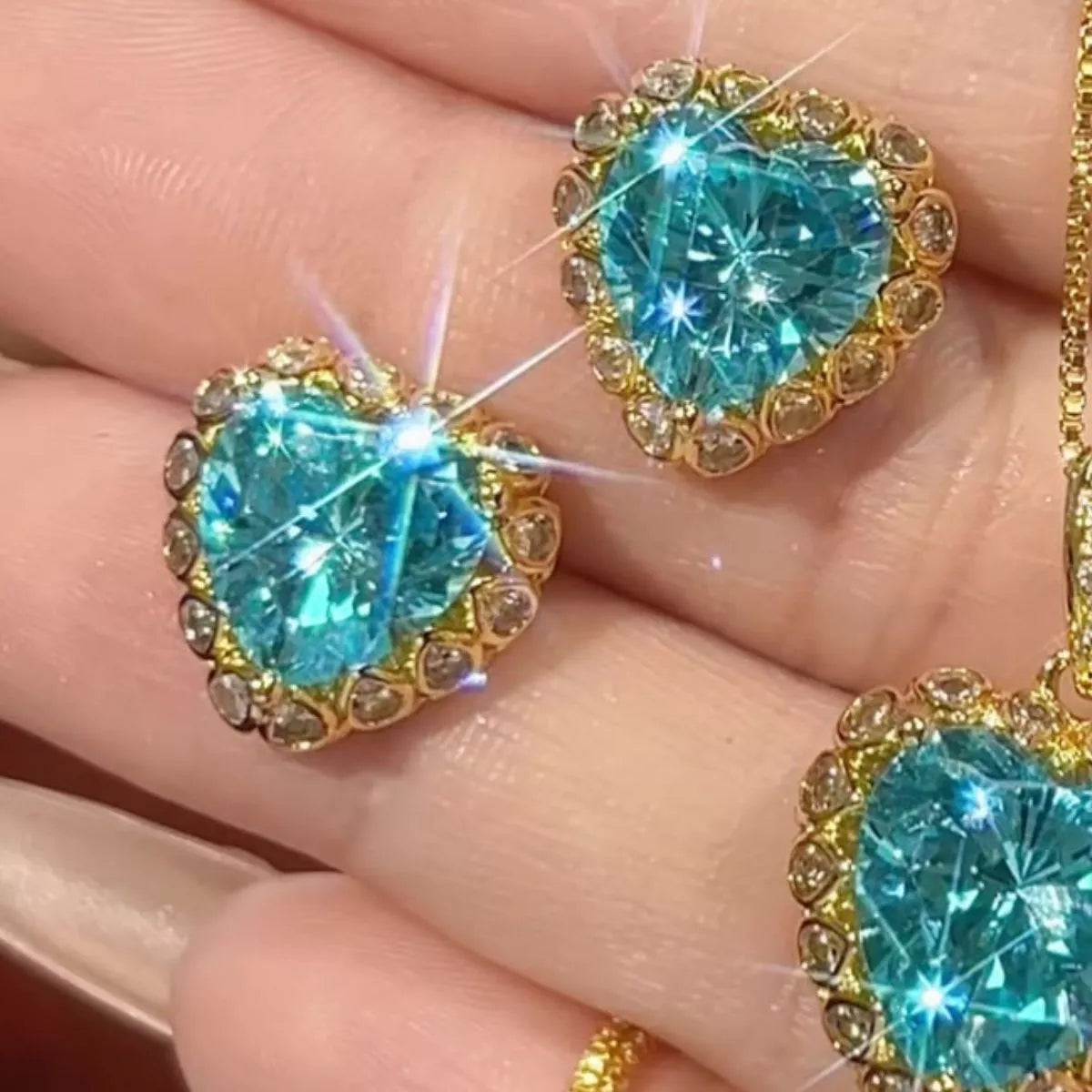 Heart-shaped blue zircon earrings with gold-plated setting and halo stones